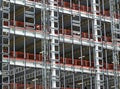 View of a large building development under construction with steel framework and girders supporting the metal floors and hoists Royalty Free Stock Photo