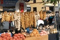 View of large bushels and strands of onions and garlic hanging in a market stall on market day in the Belgium town of Dinant
