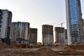 View of a large construction site with buildings under construction and multi-storey residential homes.Tower cranes in action on Royalty Free Stock Photo