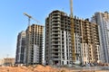 View of a large construction site with buildings under construction and multi-storey residential homes.Tower cranes in action on Royalty Free Stock Photo