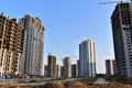 View of a large construction site with buildings under construction and multi-storey residential homes.Tower cranes in action on Royalty Free Stock Photo