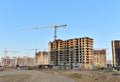 View of a large construction site with buildings under construction and multi-storey residential homes.Tower cranes in action on Royalty Free Stock Photo