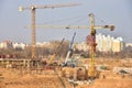 View of a large construction site. Tower cranes in action. Housing renovation concept. Crane during formworks. Construction the Royalty Free Stock Photo