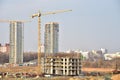 View of a large construction site. Tower cranes in action. Housing renovation concept. Crane during formworks. Construction the Royalty Free Stock Photo