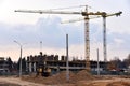 View of a large construction site. Tower cranes in action. Housing renovation concept. Crane during formworks. Construction the Royalty Free Stock Photo