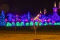 View of a Large Drive Thru Christmas Display, With Lots of Colored Lighted Tree, Buildings, Bushes