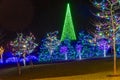 View of a Large Drive Thru Christmas Display, With Lots of Colored Lighted Tree, Buildings, Bushes