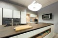 View of large flagstone cook island in modern kitchen with wood alcove