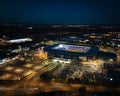 View of a large MK Dons stadium complex, illuminated at night