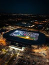 View of a large MK Dons stadium complex, illuminated at night