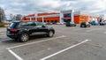 View of a large parking lot on the background of a red building. Empty parking lot, lots of parking lots. Large parking lot next