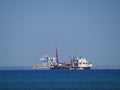 View of the large shipping container ship in the Mediterranean Sea during winter at the beach in Larnaka