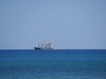 View of the large shipping container ship in the Mediterranean Sea during winter at the beach in Larnaka