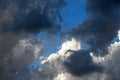 DARK GREY CLOUDS FLOATING PAST WHITE BILLOWING CLOUDS Royalty Free Stock Photo