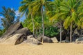 View of large stones, boulders and palm trees on the shore of the South China Sea. Sanya, China. Royalty Free Stock Photo