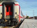 View from the last white passenger train car to the railway station during the day Royalty Free Stock Photo