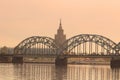 View of Latvian Academy of Sciences, Railway bridge and Daugava river on the sunrise in Riga, Latvia Royalty Free Stock Photo