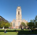 View on the Laurenskerk Laurens Church with people enjoying the sun on the Grotekerkplein in Rotterdam
