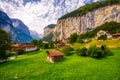 View of Lauterbrunnen town in Swiss Alps valley with gorgeous Staubbach waterfalls in the background, Switzerland