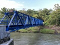 There is bridge in blue color for crossing the river. Royalty Free Stock Photo