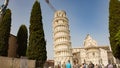 View of the leaning tower of Pisa under it a crowd of people