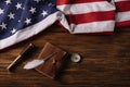 View of leather notebook, telescope, nib and compass on wooden surface with American national flag