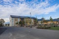 View of leaving area. House with solar panels and school building with outdoor activity children place. Sweden.