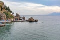 View of left side of pier in harbor of old town of Kaleici with sun loungers and vacationers  Antalya  Turkey Royalty Free Stock Photo