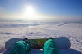 Snowboarder sitting high in mountains