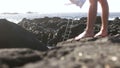 View of legs walking into the shot towards creek