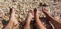 View of legs of young girl and boy on Croatian beach, pebble beach Royalty Free Stock Photo