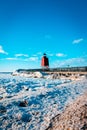 A view of the South Pier Light house and the ice dunes off of Lake Michigan in Charlevoix MI