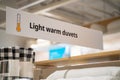 View of Light Warm duvets sign in store Royalty Free Stock Photo