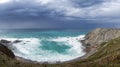 View of the lighthouse on the cliffs at Cabo Vidio under an overcast and stormy sky Royalty Free Stock Photo