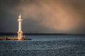 View of lighthouse on Lake Geneva with storm clouds in background. Royalty Free Stock Photo