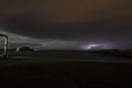 View of lightning strike over a rural farm field, lightning strikes the ground, strong thunder, lightning, dark clouds in the sky