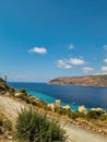 View of Limeni village with fishing boats in turquoise waters and the stone buildings as a background in Mani, Greece