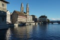 View on Limmat River bank surrounded by historical buildings enlighten by sun.