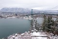 A View of Lions Gate Bridge and West Vancouver covered in snow with mountains in the background. Royalty Free Stock Photo