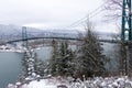 A View of Lions Gate Bridge and West Vancouver covered in snow with mountains in the background. Royalty Free Stock Photo