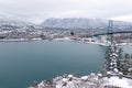 A View of Lions Gate Bridge and West Vancouver covered in snow with mountains in the background