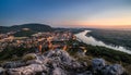 View of Lit Small City with River from the Hill at Sunset Royalty Free Stock Photo