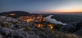 View of Lit Small City with River from the Hill at Sunset Royalty Free Stock Photo