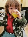 View of little girl drinking orange juice during winter Royalty Free Stock Photo