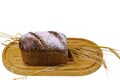 View of  loaf rye bread and rye ears on wooden cutting board isolated white background.  Food concept. Royalty Free Stock Photo