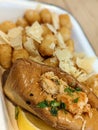 view of a lobster roll served with parmesan tots Royalty Free Stock Photo