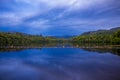 A view of Loch Faskally from the Pitlochry Dam wall at sunset, with a reflection Royalty Free Stock Photo