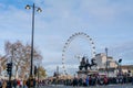 View on the London Eye and Houses of Parliament on the Thames river bank, London. Royalty Free Stock Photo