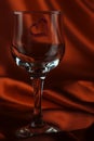 View of a lone glass of wine with a red heart