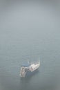 View on lonely boat and Lake Baikal under the fog Royalty Free Stock Photo